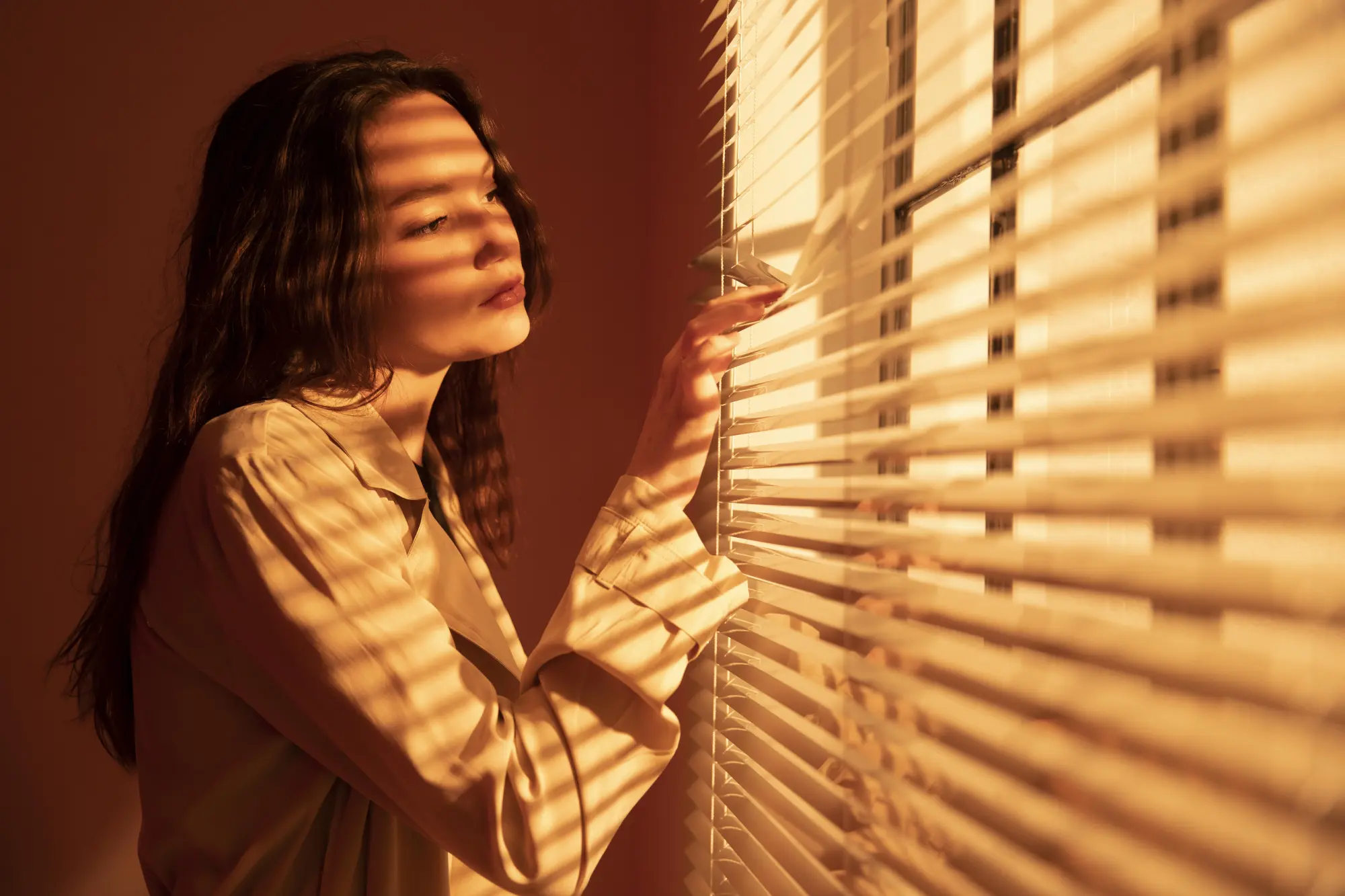 beautiful-young-woman-window-blinds.webp